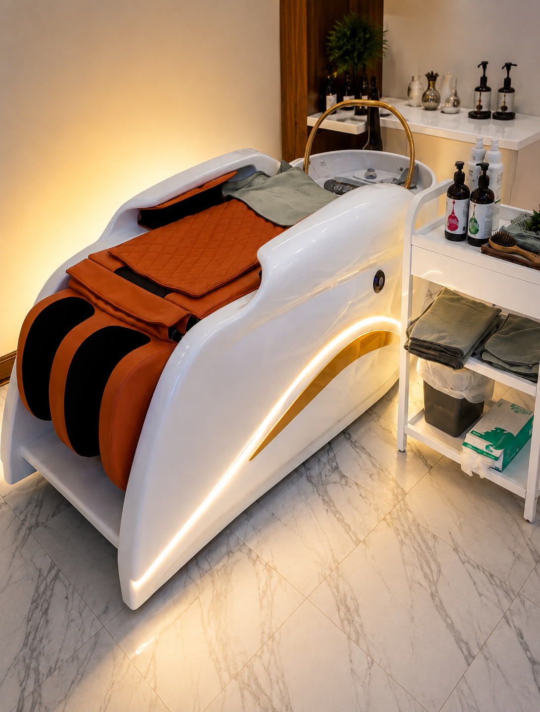 Luxury head spa treatment bed with warm gold lighting